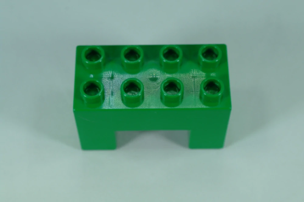 LEGO® DUPLO® kostka/cihla 2x4x2 s výřezem 2x2 - zelená